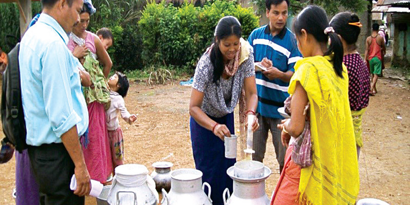 Women farmers measuring out milk as part of livelihood enhancement activities of the Manipur Dairy Initiative