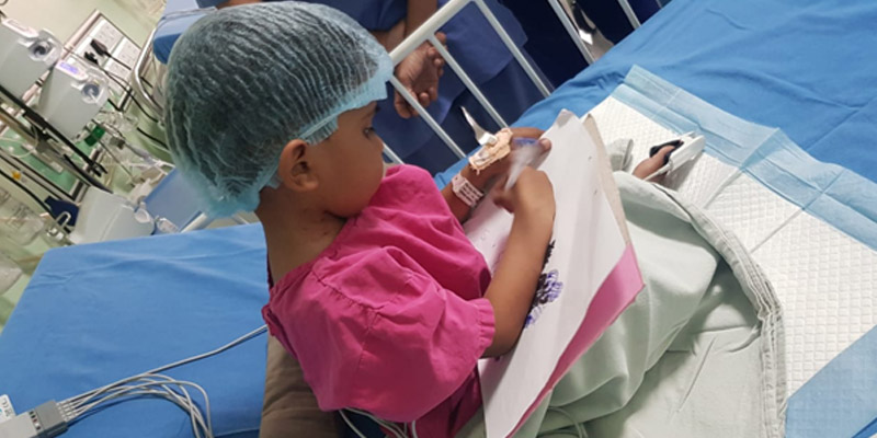 A child engaged in drawing during the recuperation period post heart surgery A child engaged in drawing during the recuperation period post heart surgery