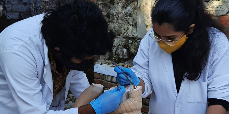 Participant-conservators at HIMSHACO preparing the dowels in a sandstone sculpture prior to joining its broken pieces