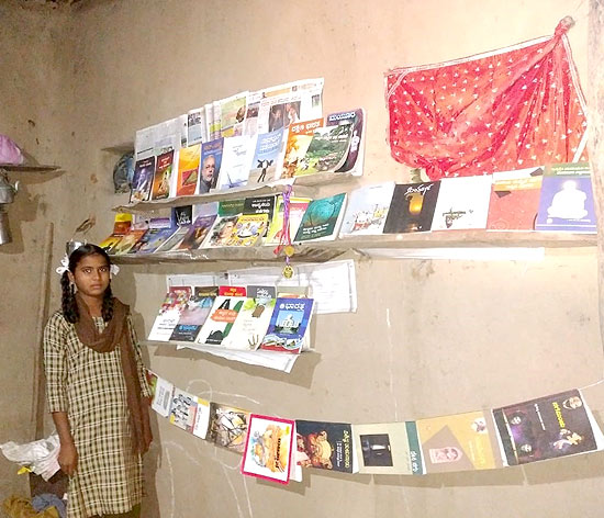 Nhina with her collection of books