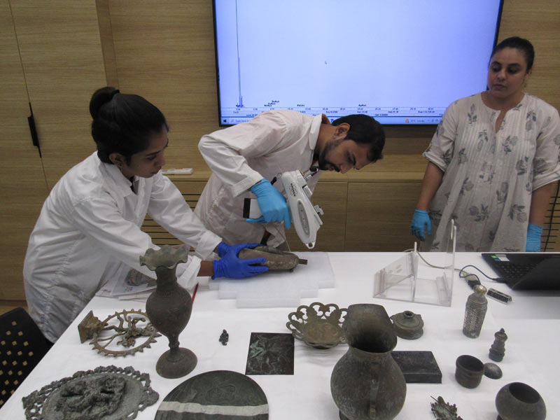 Participants undertaking XRF analysis of metal objects