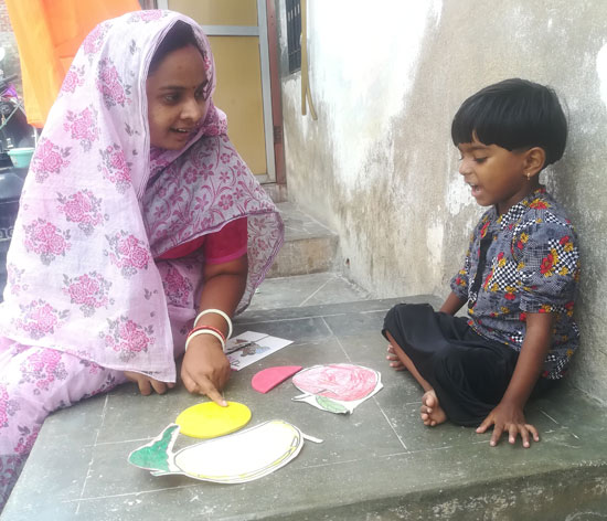 Ms Rajrani conducting ECE activities with a child at an angawadi Ms Rajrani conducting ECE activities with a child at an angawadi