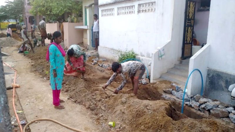 Digging trenches for laying water pipes for individual tap connection