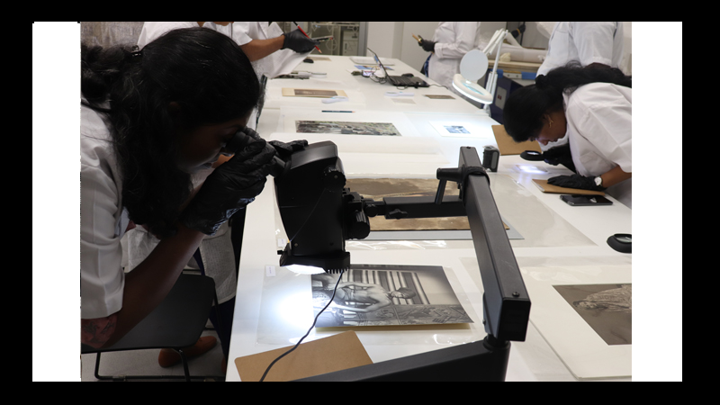 Participants viewing different types of photographs using a microscope during the offline workshop at MAP, Bangalore