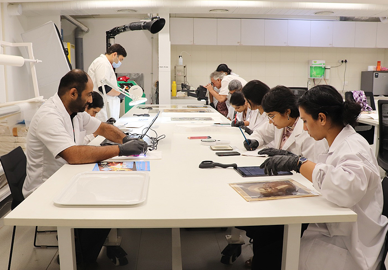 Participants engaged in different activities -identifying photographic materials and carrying out basic emergency repairs, during the offline workshop at MAP, Bangalore