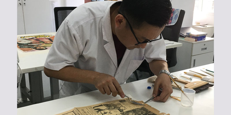 Repairing an old newspaper