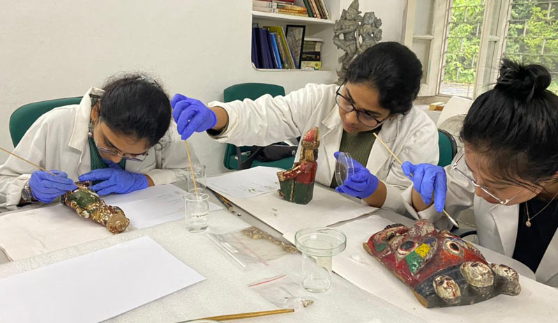 Participants undertaking cleaning of wooden objects using an experimental approach with different solvents