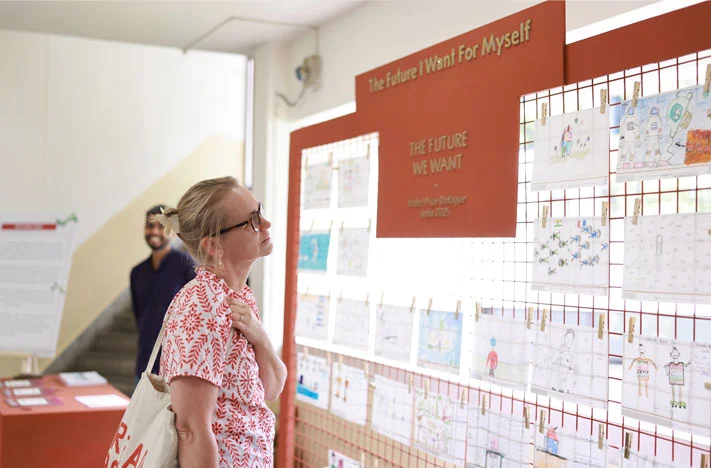 A guest explores the Parag Collab Art Wall - a showcase of children's imaginations and aspirations created through a collaboration supported by Parag, an initiative of Tata Trusts.