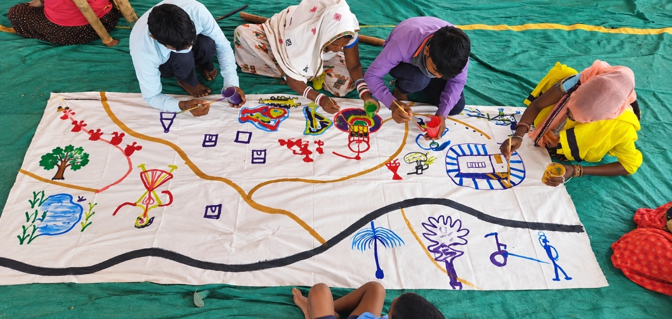 Community members engaged in a drawing activity organised by CmF in one of the target habitations