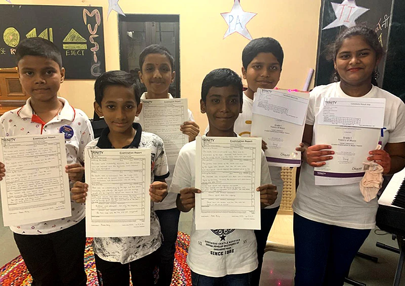 Young learners from Sion and Govandi learning centre pose with their Trinity exam certificates after clearing Level 1 in Guitar and Piano.