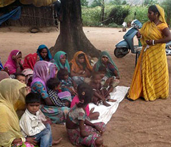 Recycling benefits: Lalita, leading a women group's meeting Recycling benefits: Lalita, leading a women group's meeting