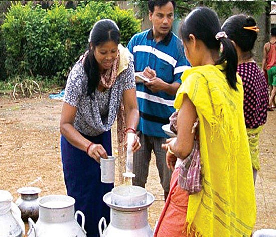 Women farmers measuring out milk as part of livelihood enhancement activities of the Manipur Dairy I Women farmers measuring out milk as part of livelihood enhancement activities of the Manipur Dairy I